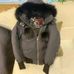 Women's red Moose Knuckles winter down jacket.